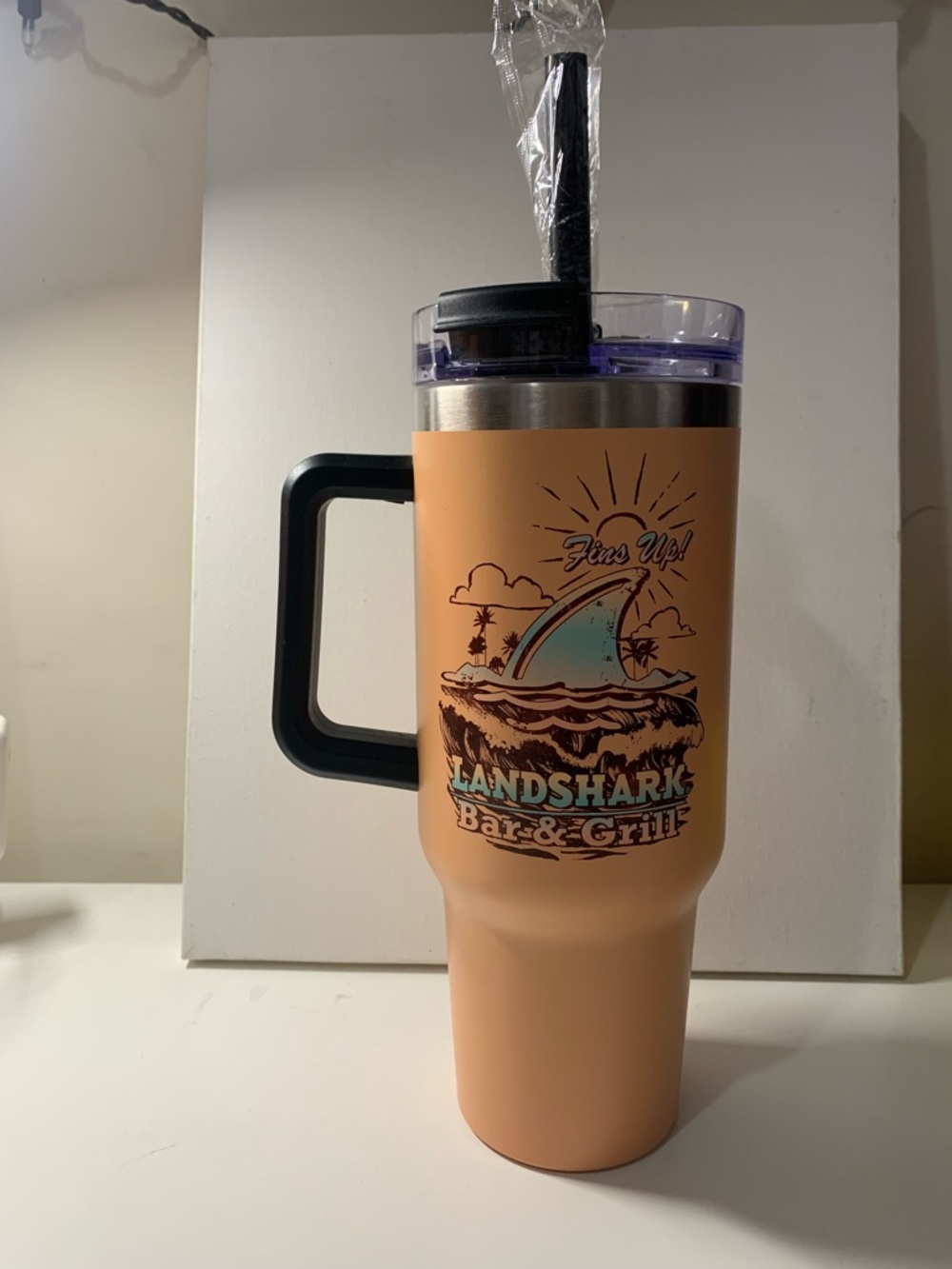 Orange tan Landshark Bar & Grill 10” tumbler with straw